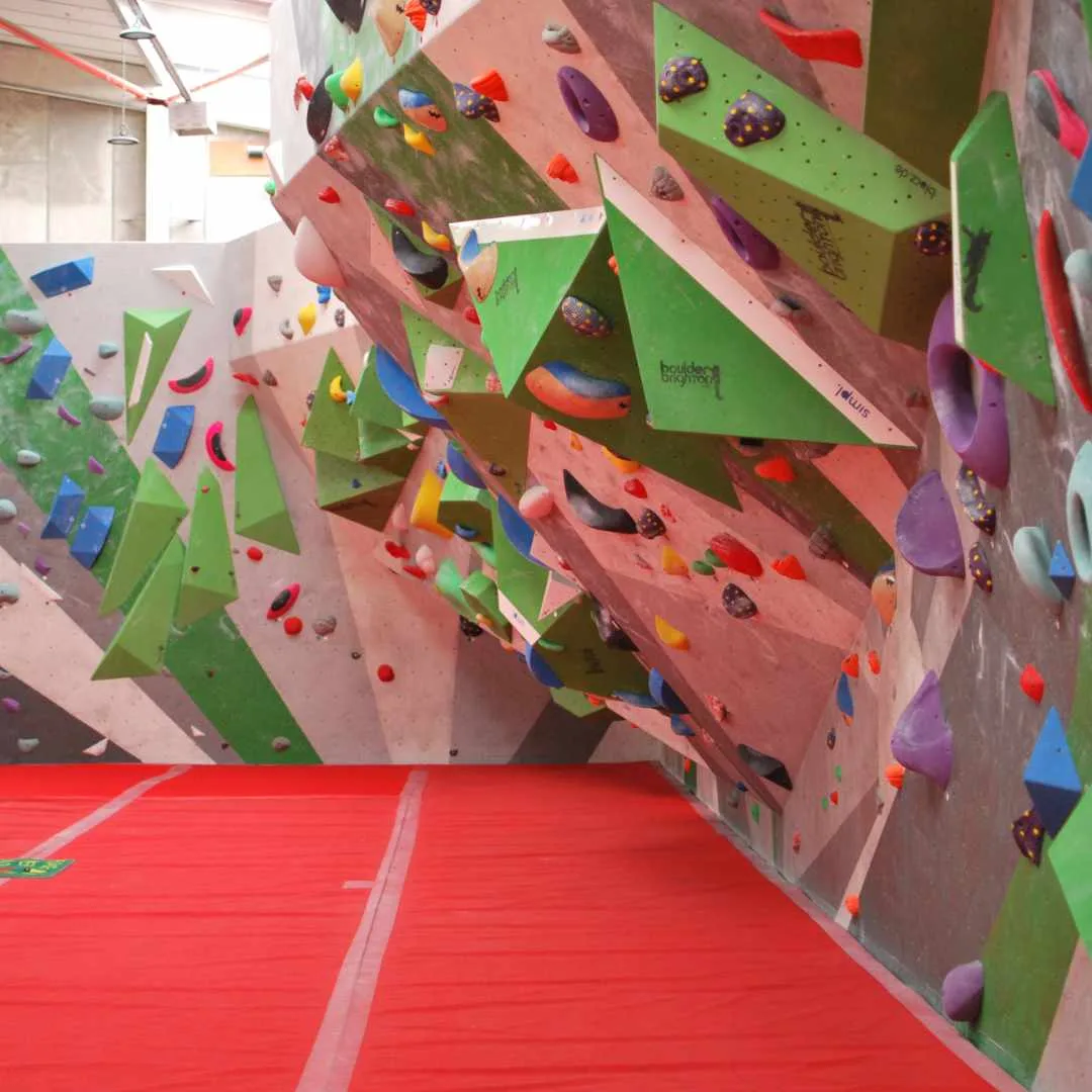 A bright slab wall above red matting