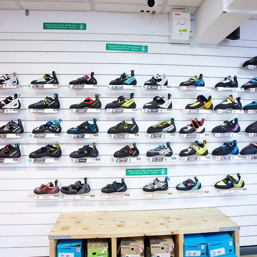 A wall of climbing shoes available to demo and buy